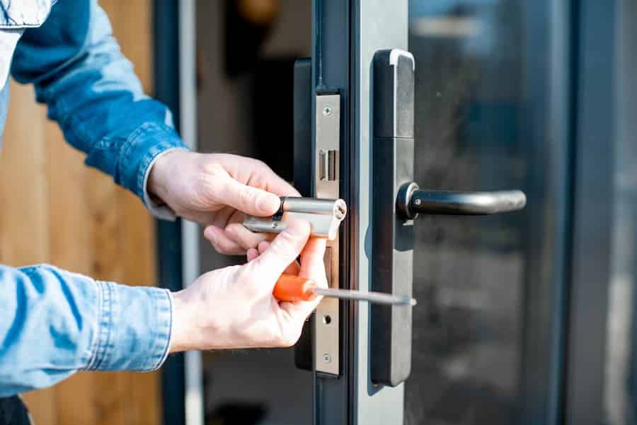 Locksmith servicing a door lock